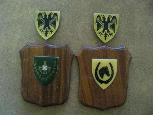 Four metal Flashes. 2 mounted on wooden shields