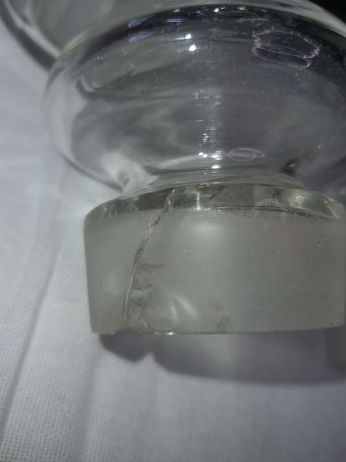 A SET OF 2 STORAGE GLASS BOTTLE CONTAINERS THE ONE LID WAS REPAIRED BEFORE SOLD AS IS