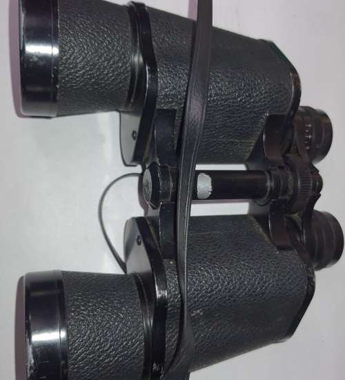 A VINTAGE BINOCULARS SOLD AS IS