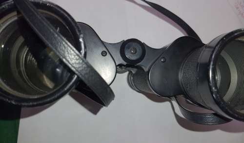 A VINTAGE BINOCULARS SOLD AS IS