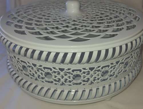 A WHITE ENAMEL PAINTED STEEL CAKE TRAY WITH AN ORNATE LID SOLD AS IS