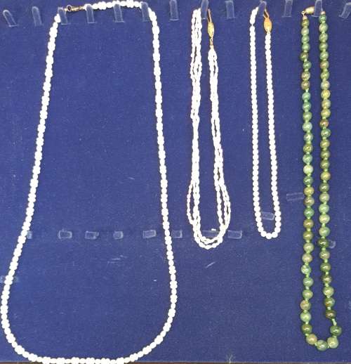 A COLLECTION OF SIMULATED PEARLS , CULTURED PEARLS AND JADE ICE NECKLACES SOLD AS IS
