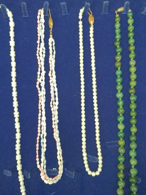 A COLLECTION OF SIMULATED PEARLS , CULTURED PEARLS AND JADE ICE NECKLACES SOLD AS IS