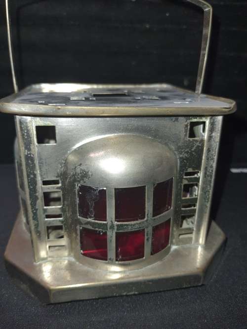 AN ANTIQUE  STAINLESS STEEL LANTETRN WITH A RED GLASS INSERT SOLD AS IS