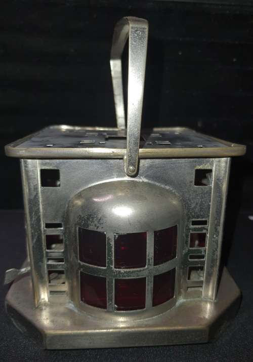 AN ANTIQUE  STAINLESS STEEL LANTETRN WITH A RED GLASS INSERT SOLD AS IS