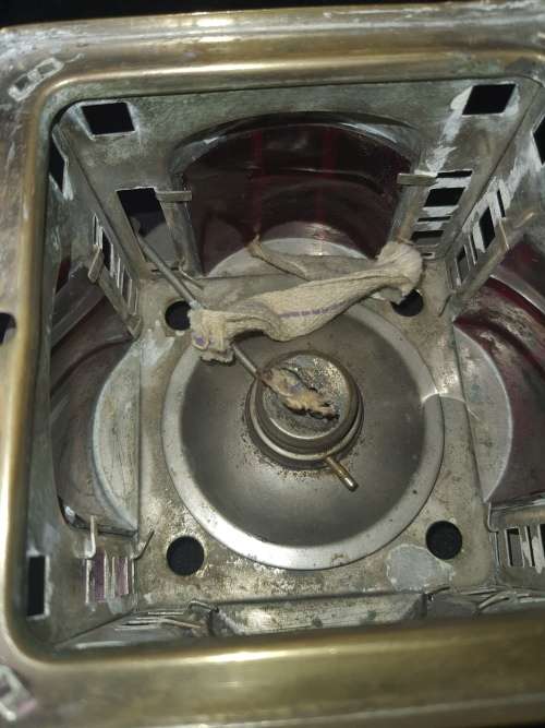 AN ANTIQUE  STAINLESS STEEL LANTETRN WITH A RED GLASS INSERT SOLD AS IS