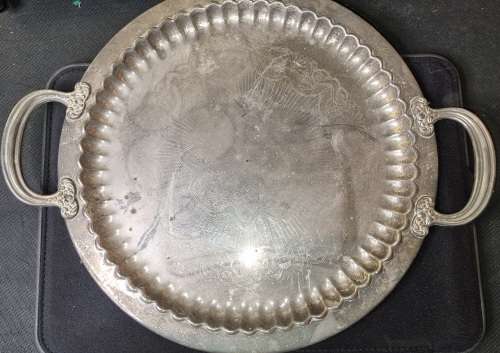 A VINTAGE ORNATELY ENGRAVED SILVER-PLATED SERVING TRAY SOLD AS IS