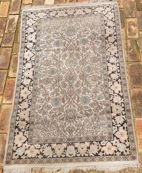AN ARABIC PERSIAN STYLE CARPET TURQUOIS AND OTHER COLOURS