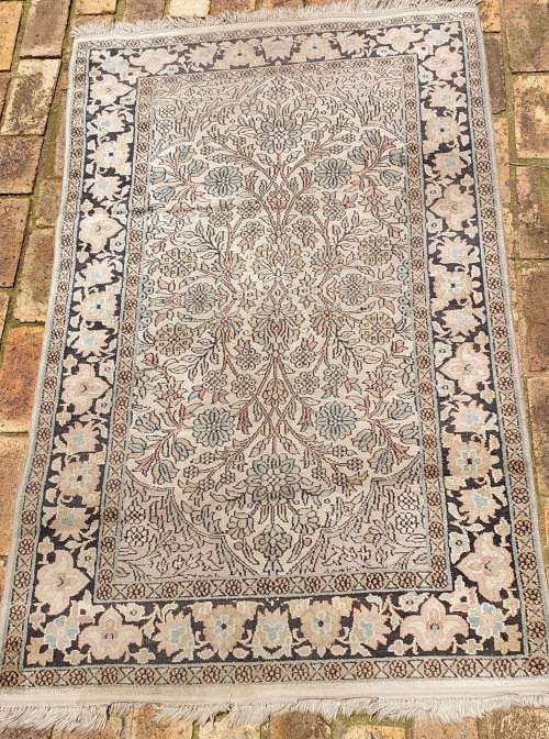 AN ARABIC PERSIAN STYLE CARPET TURQUOIS AND OTHER COLOURS