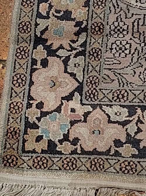 AN ARABIC PERSIAN STYLE CARPET TURQUOIS AND OTHER COLOURS