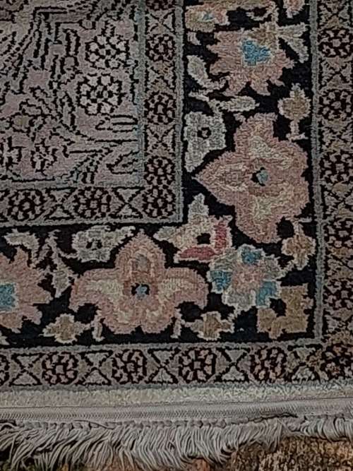 AN ARABIC PERSIAN STYLE CARPET TURQUOIS AND OTHER COLOURS