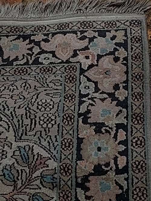AN ARABIC PERSIAN STYLE CARPET TURQUOIS AND OTHER COLOURS