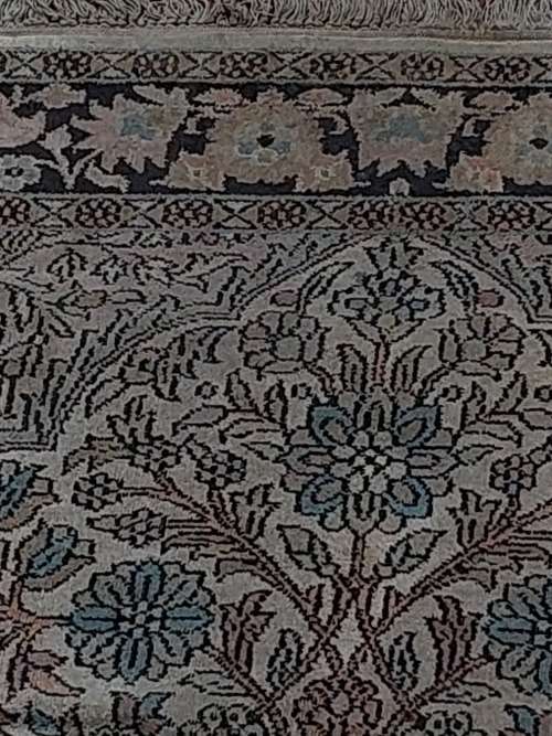 AN ARABIC PERSIAN STYLE CARPET TURQUOIS AND OTHER COLOURS