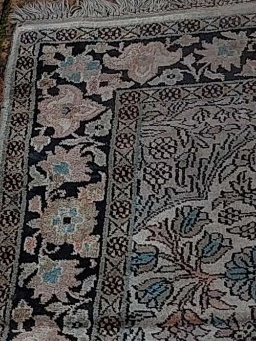 AN ARABIC PERSIAN STYLE CARPET TURQUOIS AND OTHER COLOURS