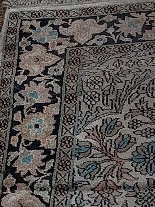 AN ARABIC PERSIAN STYLE CARPET TURQUOIS AND OTHER COLOURS