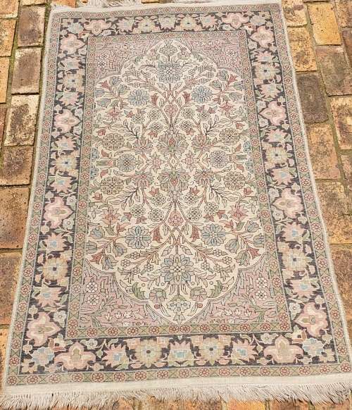 AN ARABIC PERSIAN STYLE CARPET TURQUOIS AND OTHER COLOURS