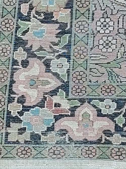 AN ARABIC PERSIAN STYLE CARPET TURQUOIS AND OTHER COLOURS