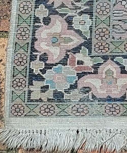AN ARABIC PERSIAN STYLE CARPET TURQUOIS AND OTHER COLOURS