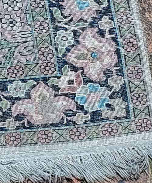 AN ARABIC PERSIAN STYLE CARPET TURQUOIS AND OTHER COLOURS