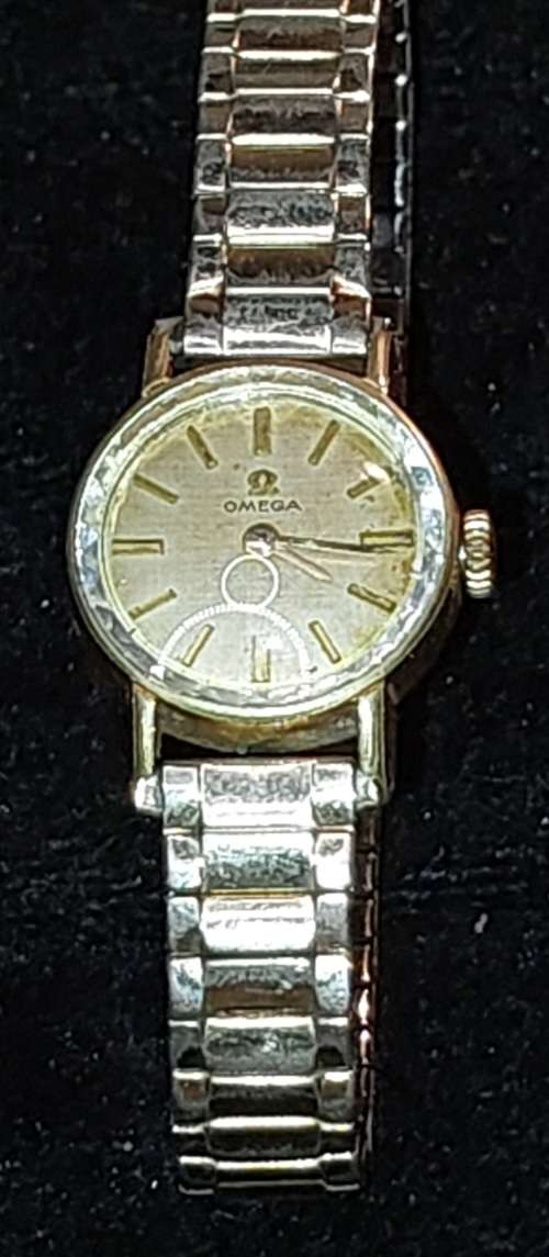 AN ANTIQUE OMEGA WOMANS WATCH SOLD AS IS NOT TESTED