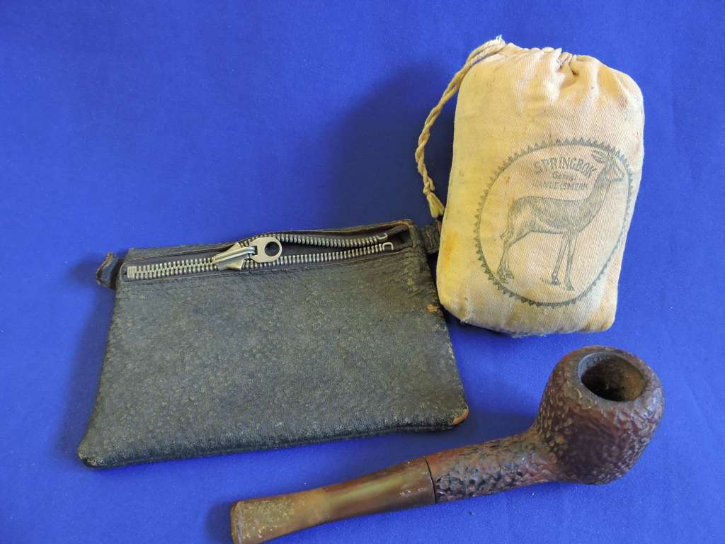 Vintage smoking pipe with Springbok tabak sak and leather tobacco pouch.