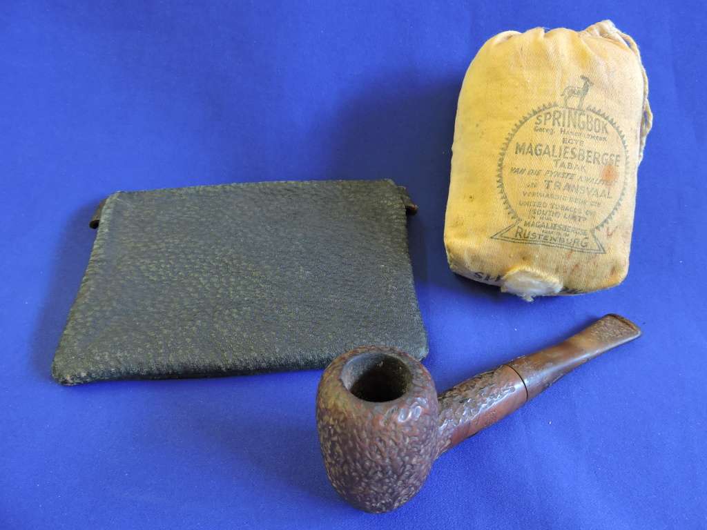 Vintage smoking pipe with Springbok tabak sak and leather tobacco pouch.