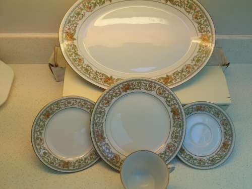 Noritake complete 12 place settings.Teresa pattern.Platter, sauce boat.