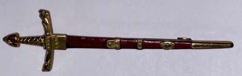 A Miniature Sword pendant.