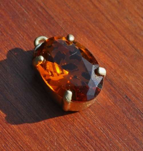 Vintage 1950s Faceted Oval Amber Glass Crystal prong set pendant in hand pierced gold tone mount