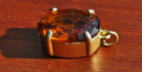Vintage 1950s Faceted Oval Amber Glass Crystal prong set pendant in hand pierced gold tone mount