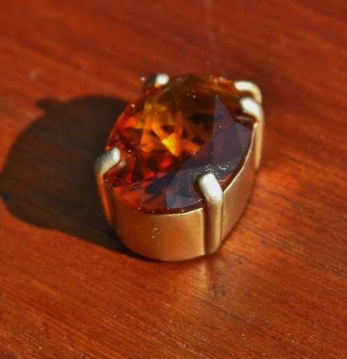 Vintage 1950s Faceted Oval Amber Glass Crystal prong set pendant in hand pierced gold tone mount