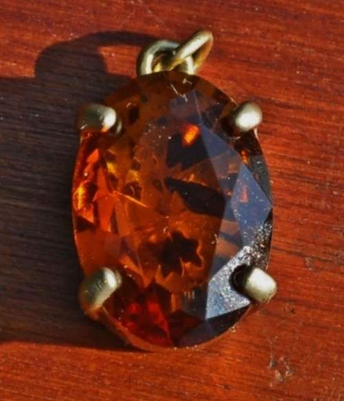 Vintage 1950s Faceted Oval Amber Glass Crystal prong set pendant in hand pierced gold tone mount