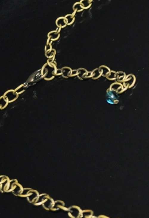 Vintage brass costume jewellery necklace with green and clear crystal