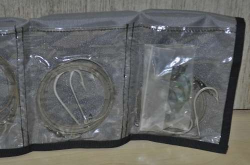 Kingfisher Sail Pouch with variety of traces, Mustad hooks, a Lure, Lead sinkers, and more