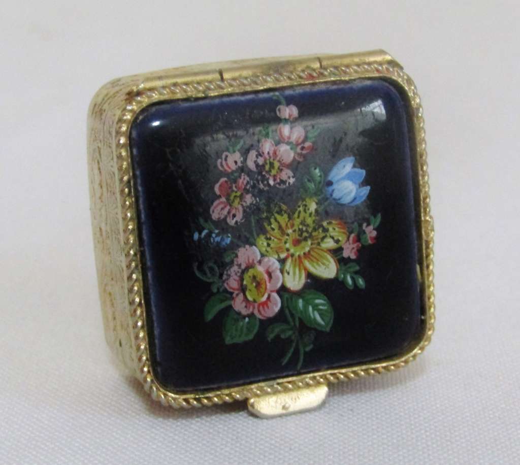 Small square gold tone pill box with cobalt blue floral bouquet ceramic decoration