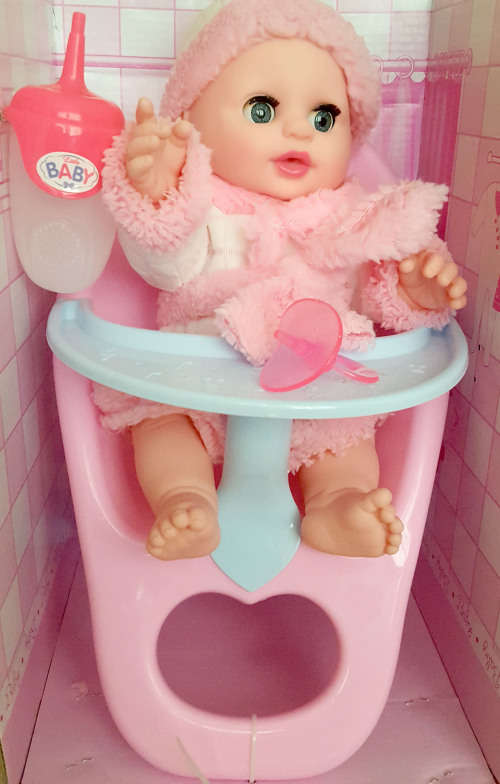 Absolutely beautiful baby doll with feeding chair.