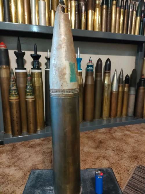 Shell 90mm case and impact damaged practice projectile
