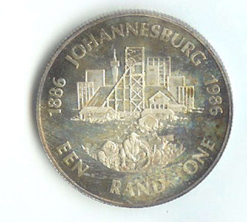 A 1986 JOHANNESBURG PROOF COIN IN A BLUE SAM CASE.