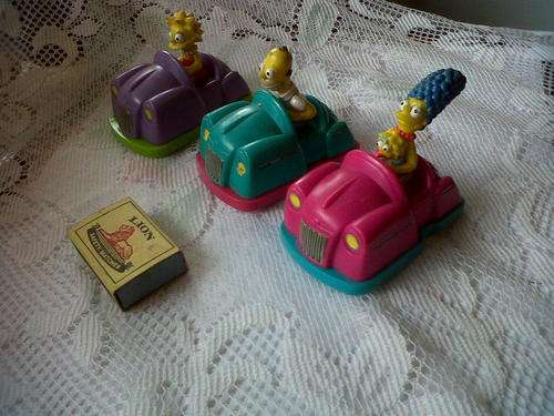 Three(3) Simpson Family members in cars.