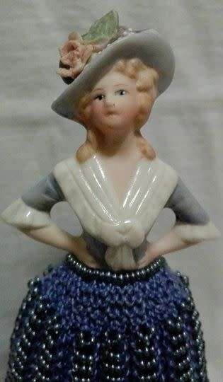 Porcelain half doll with beaded dress. Beautiful!!
