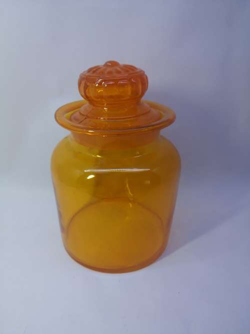 Bright orange glass bottle and glass lid