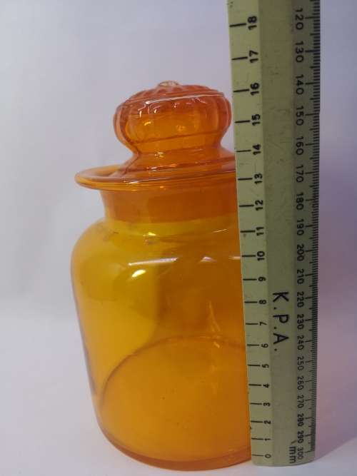 Bright orange glass bottle and glass lid