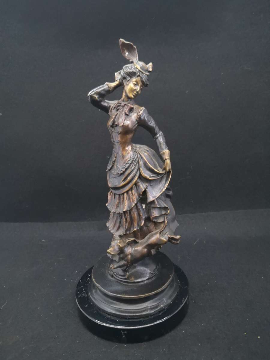 Heavy cast metal woman with sausage dog