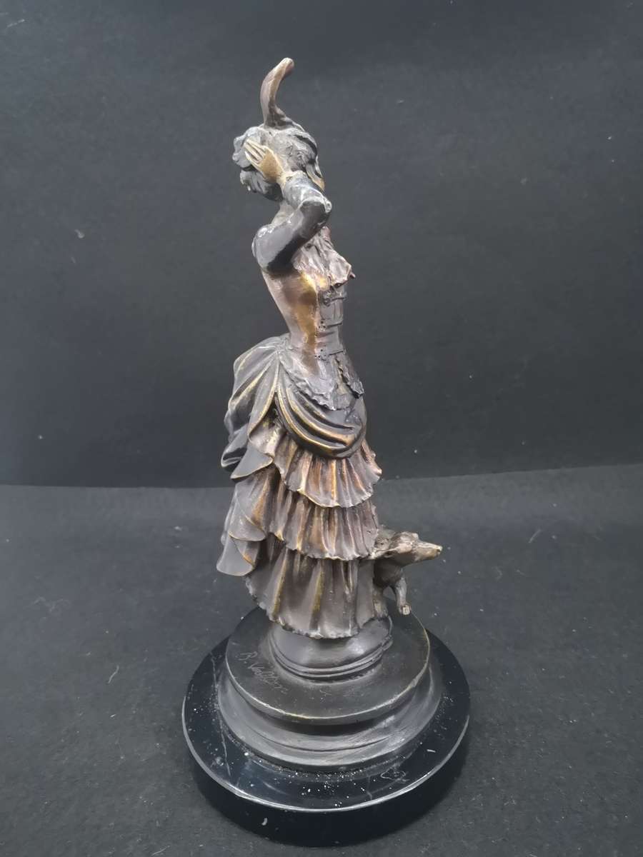 Heavy cast metal woman with sausage dog