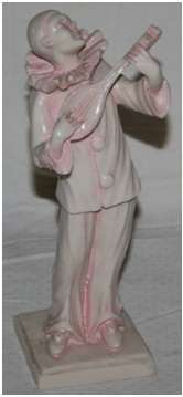 A RESIN IVORY CLOWN PLAYING THE BANJO