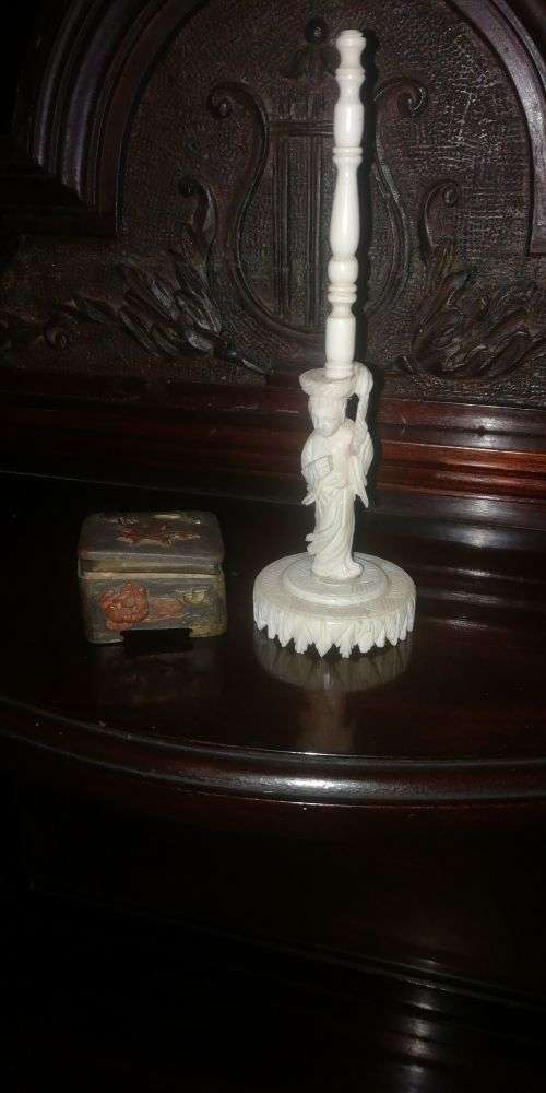 An ivory carved miniature figure and metal box