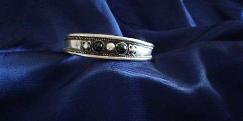 A Tibetan silver bracelet set with stones