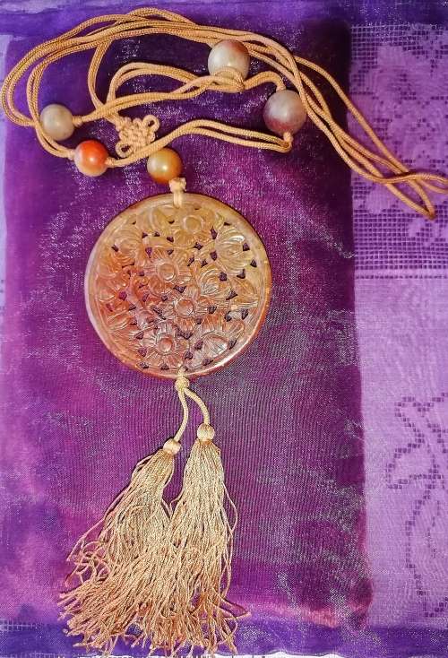 A superb carved red jade amulet necklace