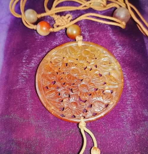 A superb carved red jade amulet necklace