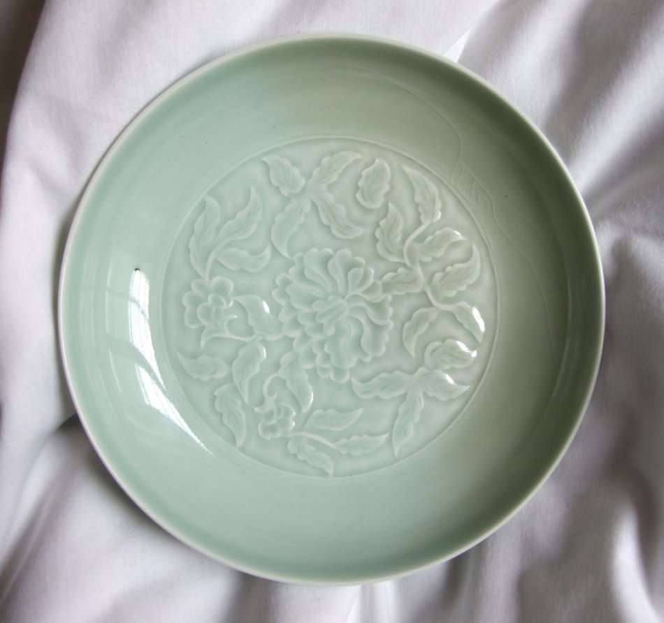 An old Chinese Celadon bowl with chrysanthemum embossing